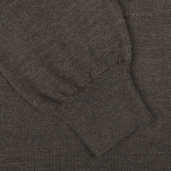 Close-up of a dark brown melange knitted fabric with a ribbed cuff, crafted from luxurious merino wool by Gran Sasso for their Brown Melange Merino Wool Roll Neck.