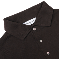 Close-up of the Brown Merino Wool One-Piece Collar Polo Shirt by Gran Sasso, featuring three buttons and a tag labeled "Gran Sasso Italy" at the neckline.