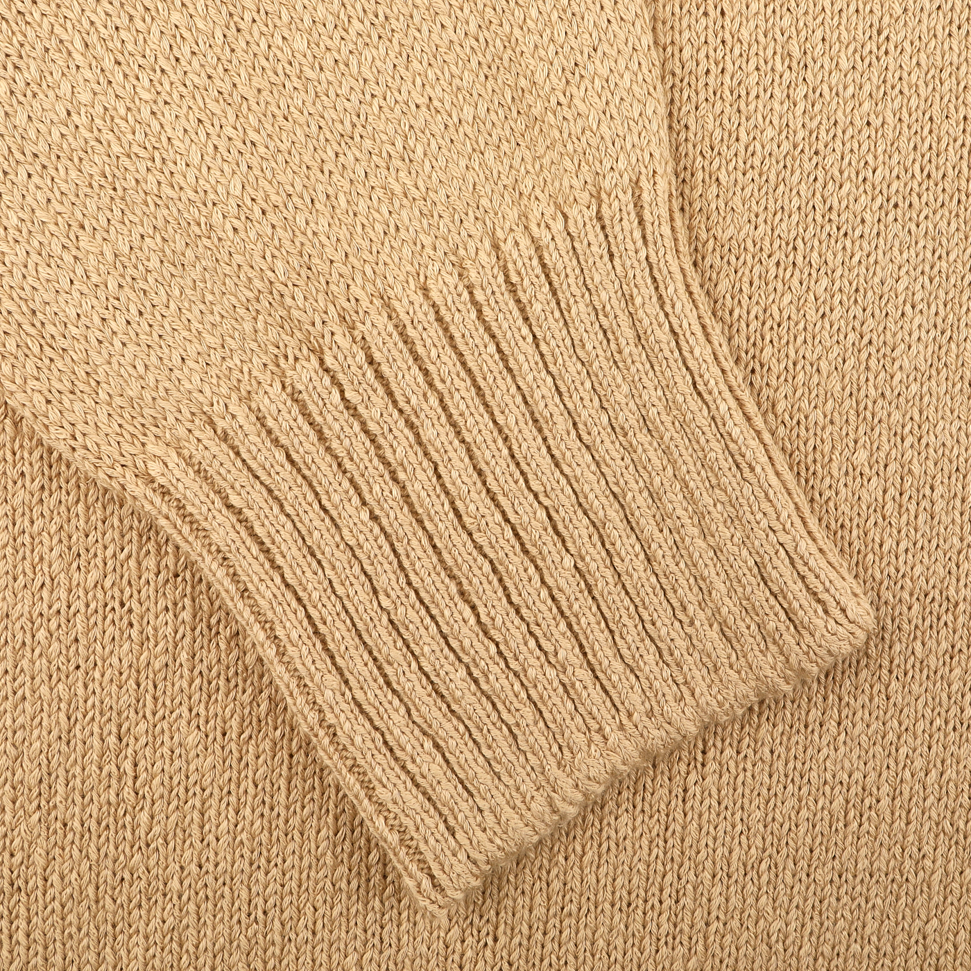 Close-up of a sleeve from the Gran Sasso Camel Beige Cotton Boucle Full Zip Cardigan, highlighting the intricate texture and stitching of its pure cotton boucle fabric with ribbed cuff.