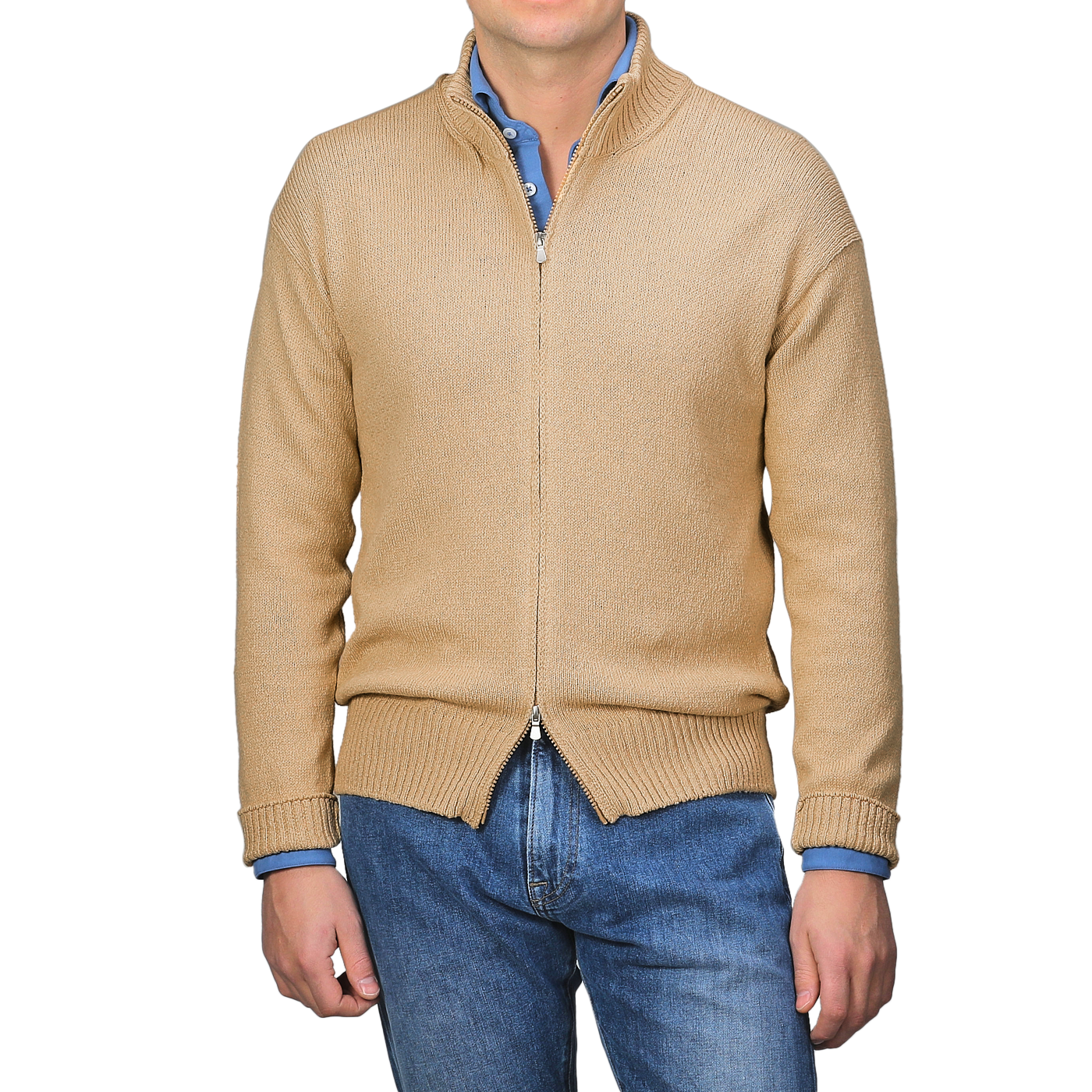 A man models the art of seasonal layering with a relaxed stance, showcasing the Gran Sasso Camel Beige Cotton Boucle Full Zip Cardigan over a blue shirt and jeans.