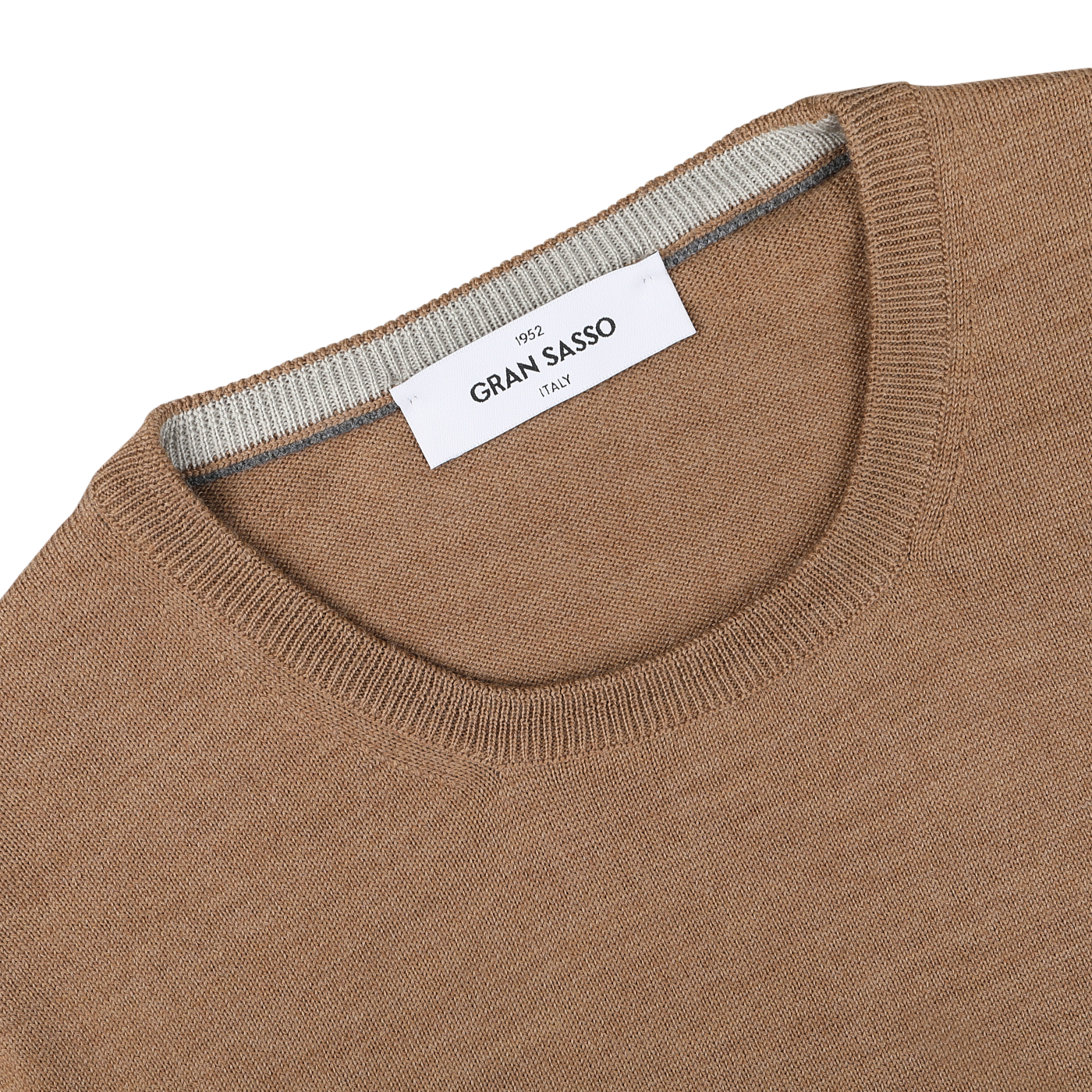 Close-up of a Camel Beige Extra Fine Merino Crew Neck sweater made by Gran Sasso, featuring a white tag inside the crew neck collar that says "Gran Sasso Italy.