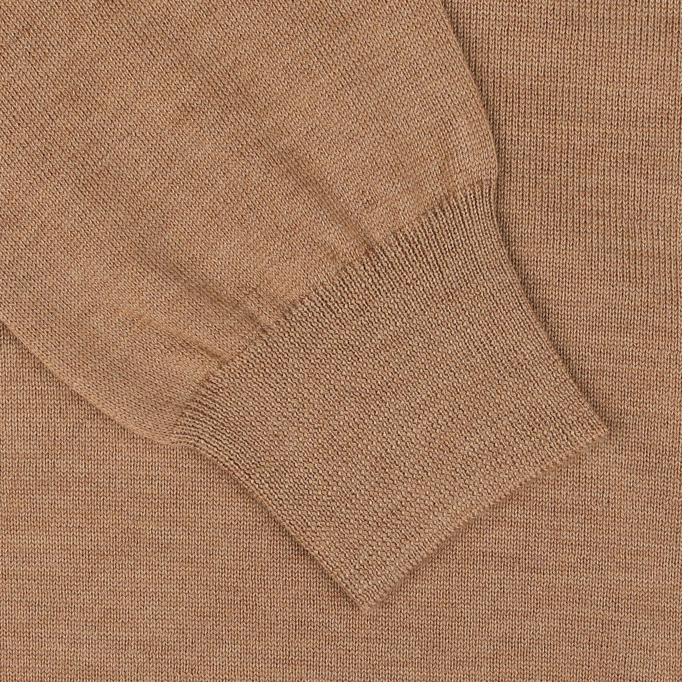 Close-up of a camel beige extra fine merino crew neck sweater sleeve with a ribbed cuff, crafted from luxurious virgin wool by Gran Sasso.