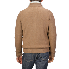 A person is seen from the back wearing a Camel Beige Faux Fur Lined Cashmere Blouson by Gran Sasso with blue jeans.