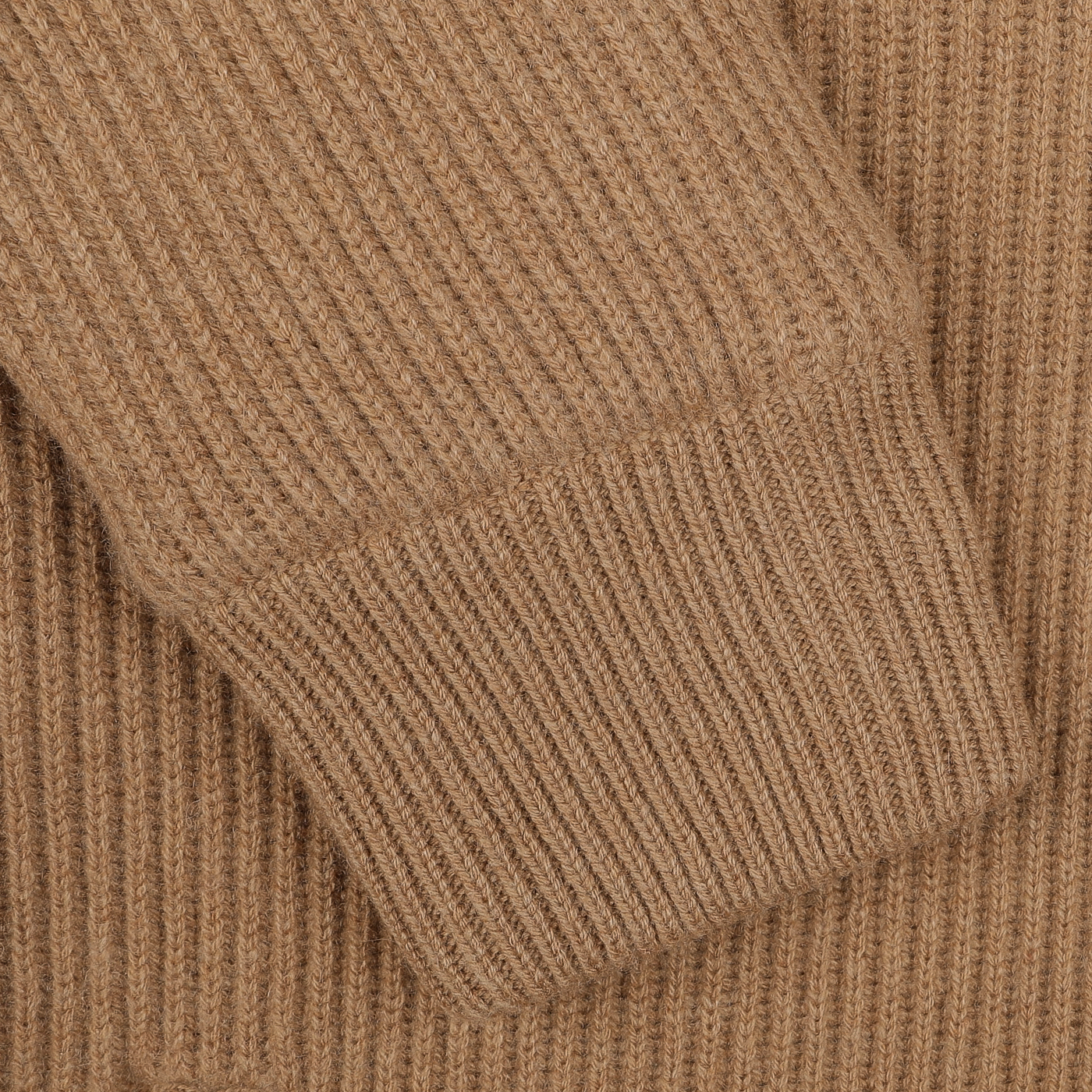 Close-up of an exquisite knitwear piece, the rich fabric showcases the detailed craftsmanship of a sleeve cuff from Gran Sasso's Camel Beige Faux Fur Lined Cashmere Blouson.