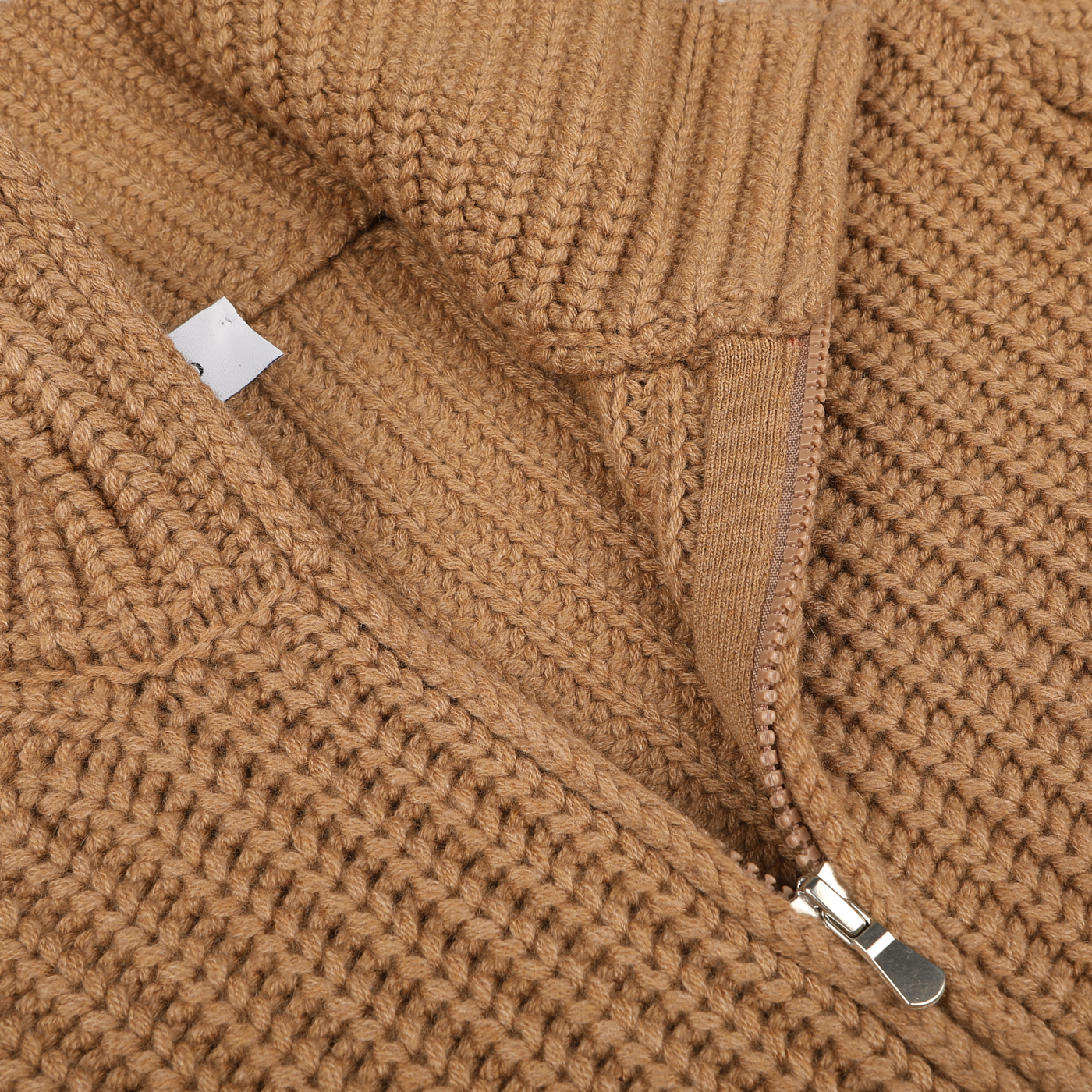 A close-up of the Gran Sasso Camel Wool Cashmere Heavy Knit Cardigan, featuring a partially open zipper with a metal pull tab. The wool cashmere viscose cardigan displays a ribbed texture.