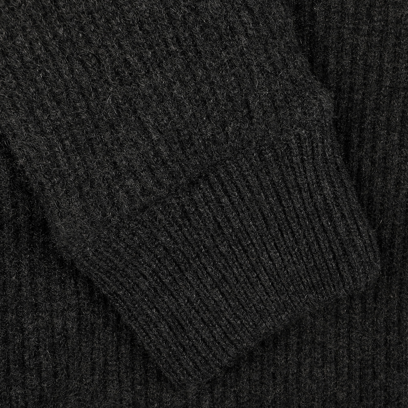 Close-up of a sleeve from Gran Sasso's Charcoal Faux Fur Lined Cashmere Blouson, highlighting its ribbed texture and fine stitching.