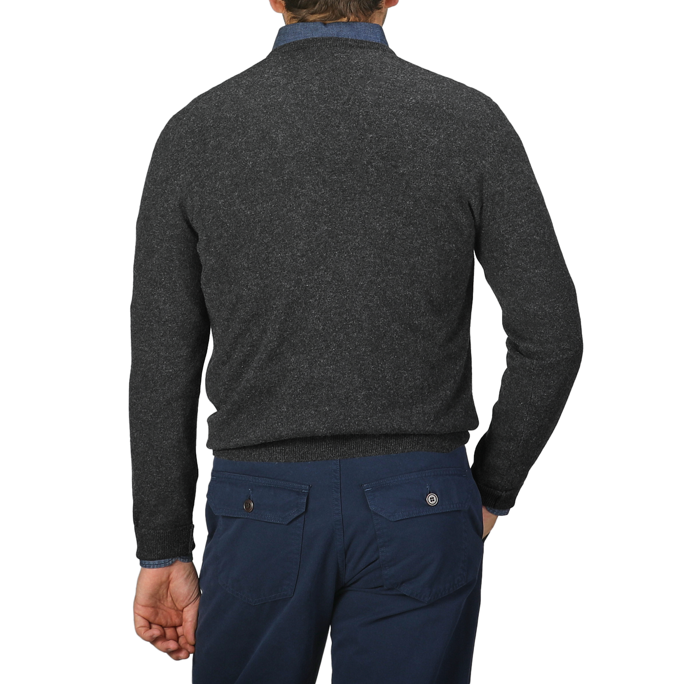 A person is shown from the back against a plain background, wearing a Charcoal Grey Cashmere V-Neck Sweater by Gran Sasso and dark blue pants, both meticulously crafted from pure cashmere fibers.