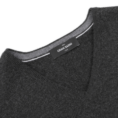 The Charcoal Grey Cashmere V-Neck Sweater by Gran Sasso is crafted from pure cashmere fibers, offering the elegance and luxurious feel of sustainable knitwear.