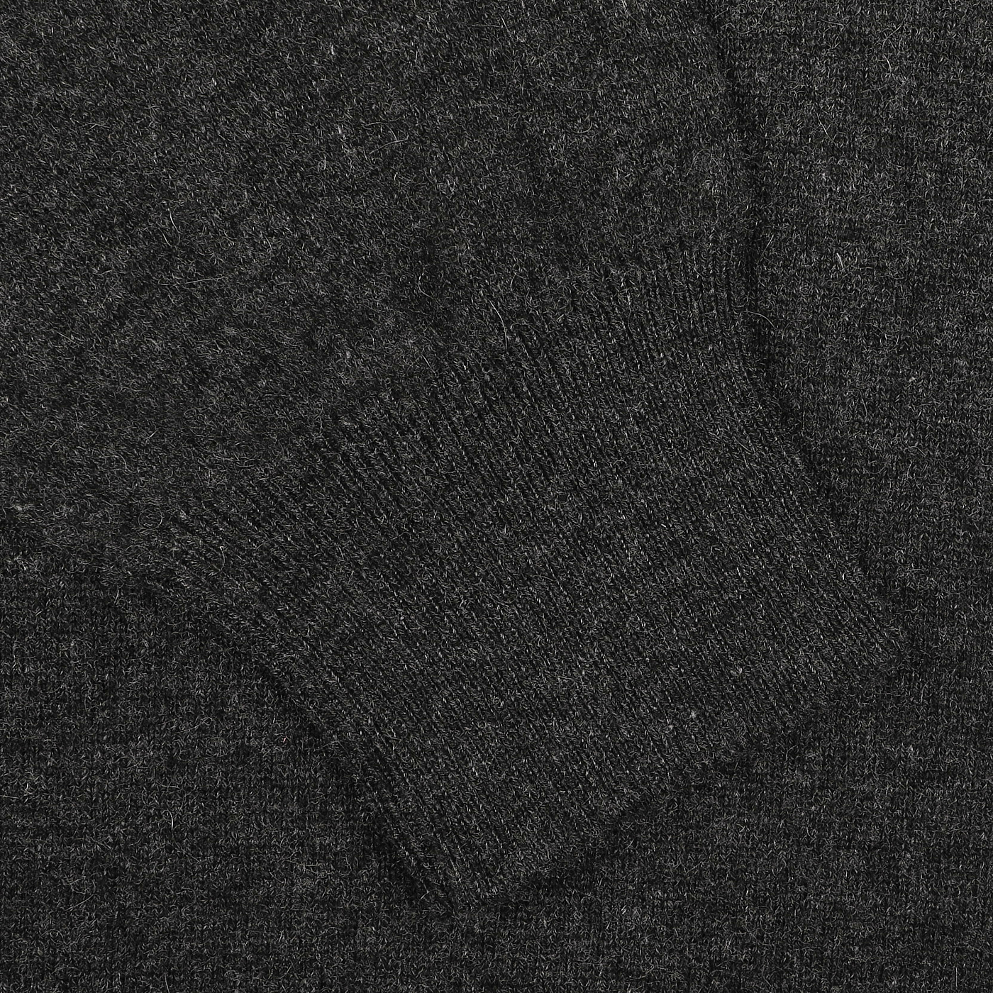 Featured is a close-up of the elegant Charcoal Grey Cashmere V-Neck Sweater by Gran Sasso, highlighting its sustainable knitwear with exquisite ribbed textures.