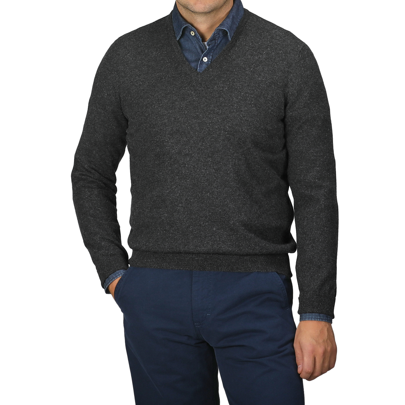 A person wearing Gran Sasso's Charcoal Grey Cashmere V-Neck Sweater over a denim shirt, paired with dark blue pants, stands against a neutral background.