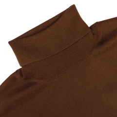 Close-up of a slim-fit Cinnamon Brown Extra Fine Merino Rollneck by Gran Sasso, showcasing the neckline and top of the shoulders against a plain background.