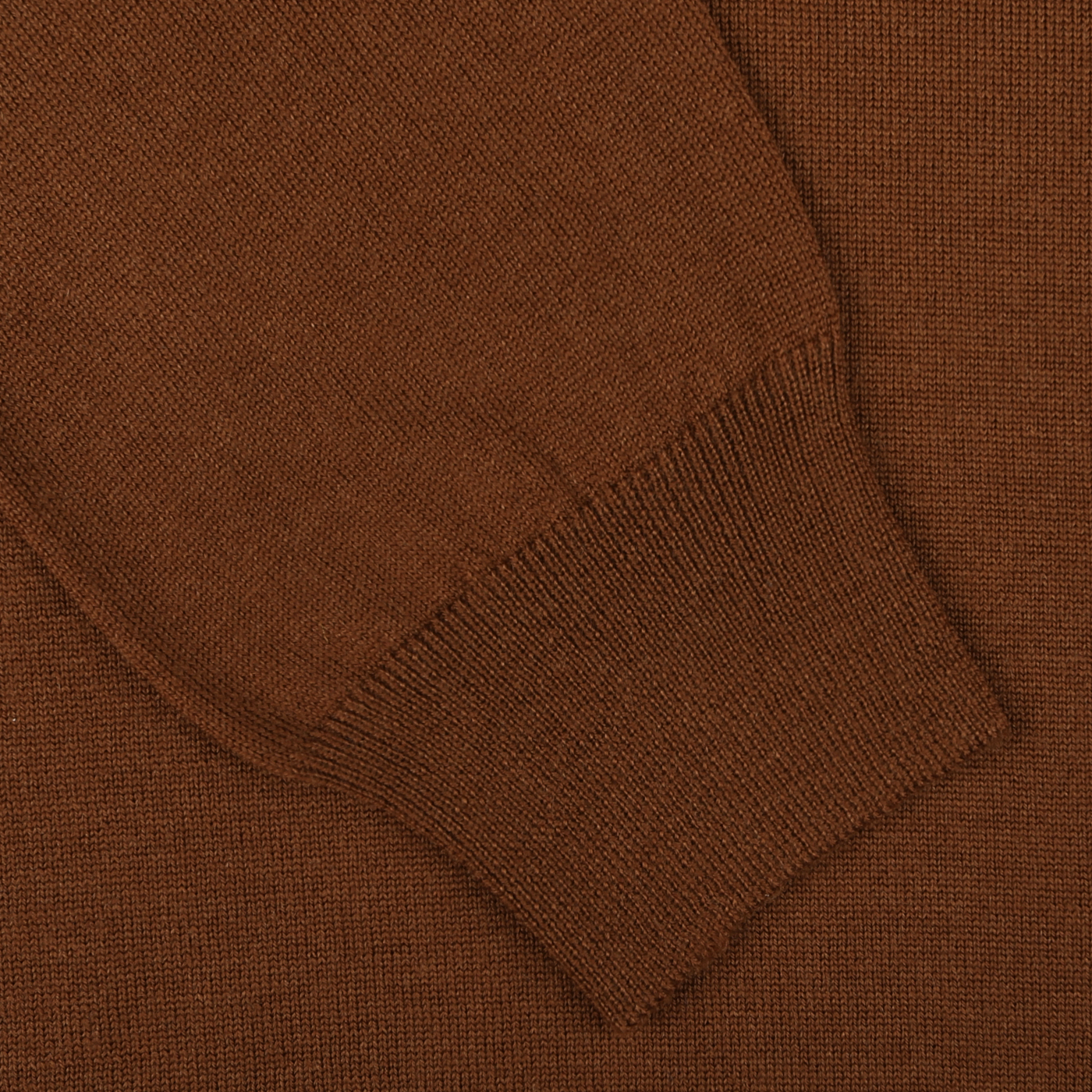 Close-up of a brown knitted fabric showcasing the sleeve and cuff area of a Gran Sasso Cinnamon Brown Extra Fine Merino Rollneck garment. The texture and stitching details are clearly visible.