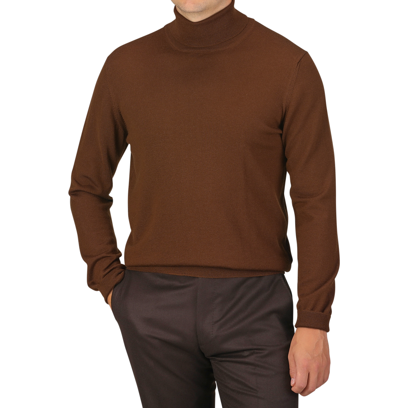 A person wearing a slim fit, Cinnamon Brown Extra Fine Merino Rollneck by Gran Sasso and dark brown pants stands with one hand in their pocket against a plain white background.