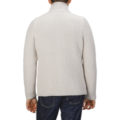 Person in a Gran Sasso Cream Beige Chunky Knitted Wool Cardigan and dark jeans, standing with their back facing the camera.