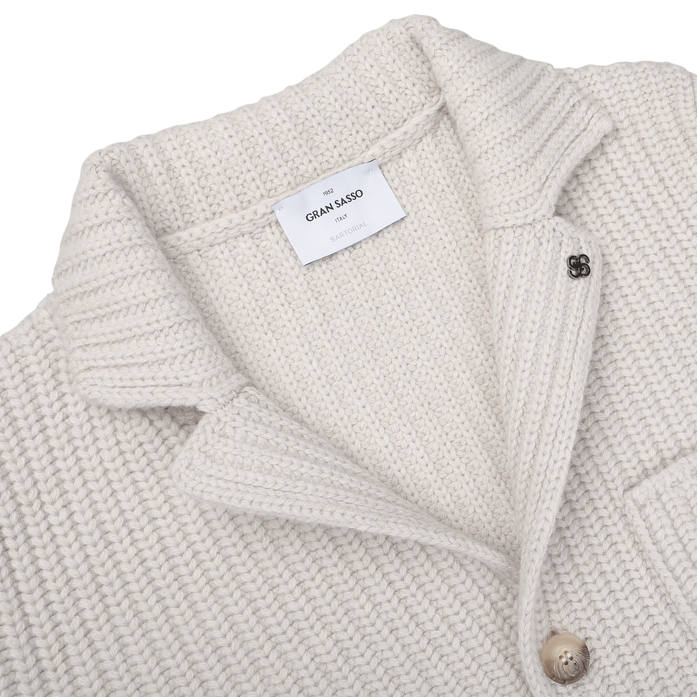 Close-up of a Cream Beige Chunky Knitted Wool Cardigan by Gran Sasso, featuring a folded collar, a label reading "Gran Sasso," and a buttoned pocket.