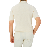 The back view of a man wearing a Gran Sasso Cream Beige Cotton Linen Polo Shirt.
