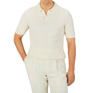 A man, dressed in a Cream Beige Cotton Linen Polo Shirt from Gran Sasso, completes his outfit with matching pants.