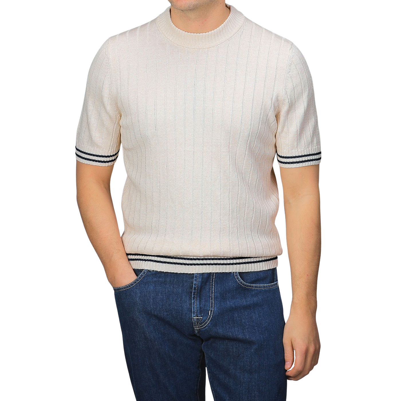 A person in a Gran Sasso slim fit light-colored Cream Beige Cotton Linen T-Shirt with black trim and blue jeans, hands in pockets.