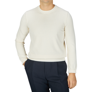 A man wearing a Gran Sasso Cream Beige Egyptian Cotton Crewneck Sweater and black pants.