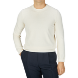 A man wearing a Gran Sasso Cream Beige Egyptian Cotton Crewneck Sweater and black pants.