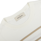 Close-up of a cream beige striped organic cotton t-shirt with a Gran Sasso neck label displaying the brand "gran sasso" and size "xxl".