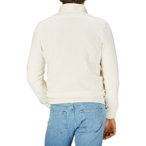 The back view of a man wearing a Gran Sasso Cream Beige Travel Wool Hybrid Jacket and jeans.