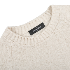 The Cream Cotton Boucle Crewneck Sweater by Gran Sasso is perfect for layering, featuring a ribbed neckline and a black "Gran Sasso Italy" label inside. Crafted from pure cotton boucle, it combines style with comfort.