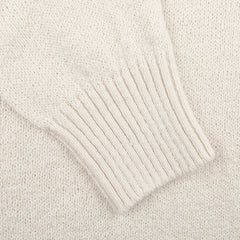 Close-up of a Gran Sasso Cream Cotton Boucle Crewneck Sweater sleeve, featuring ribbed cuff detail, ideal for layering.