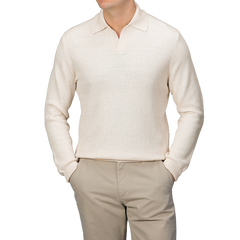 A person wears a slim fit Cream Cotton Linen LS Polo Shirt by Gran Sasso, paired with beige pants, hands casually tucked in pockets against a gray backdrop.