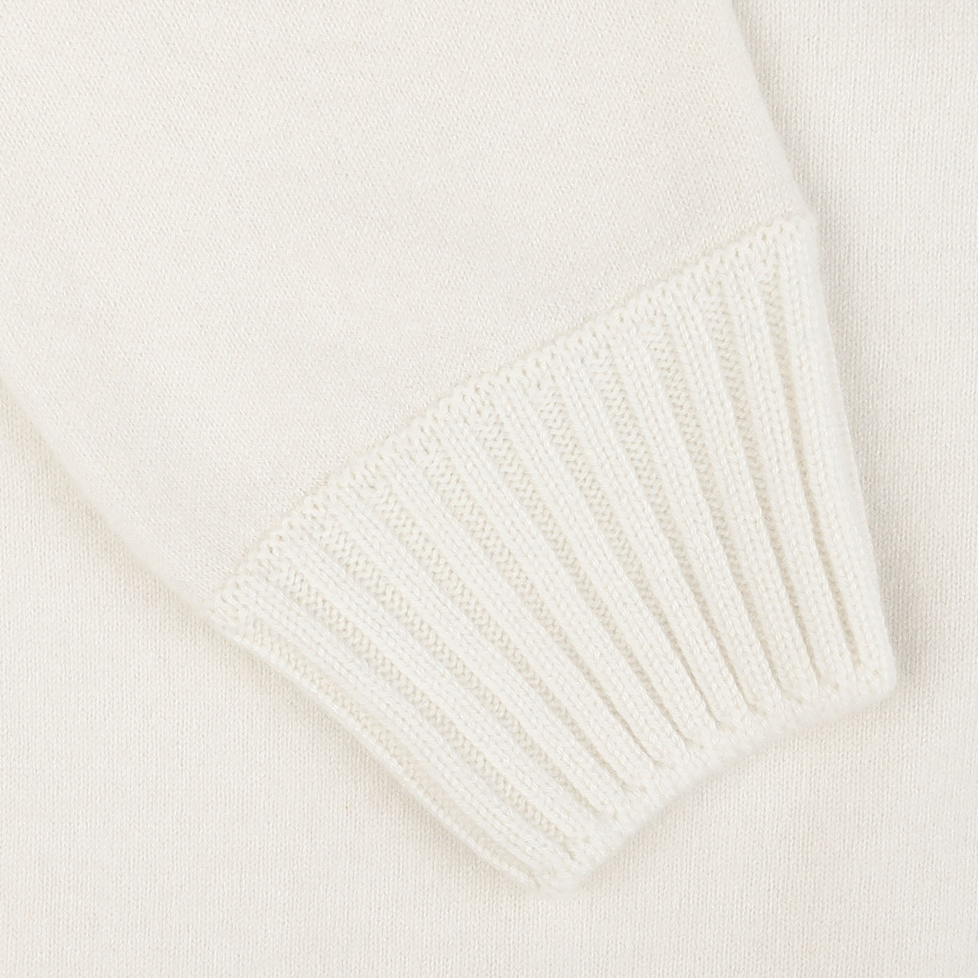 Close-up of a Cream Felted Cashmere Zip Cardigan sleeve by Gran Sasso, featuring a finely ribbed cuff, showcasing its contemporary fit.