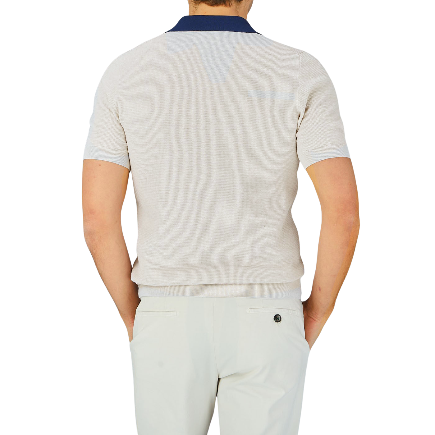 The back view of a man wearing a Gran Sasso Cream Fresh Cotton Contrast Collar Polo Shirt and white pants made of cotton.
