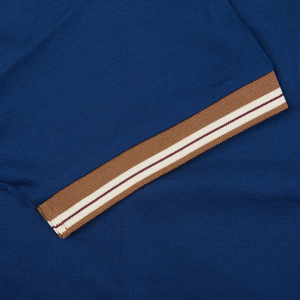A close up of a Dark Blue Filo Scozia Zip Polo Shirt with a brown stripe, made from Gran Sasso cotton.