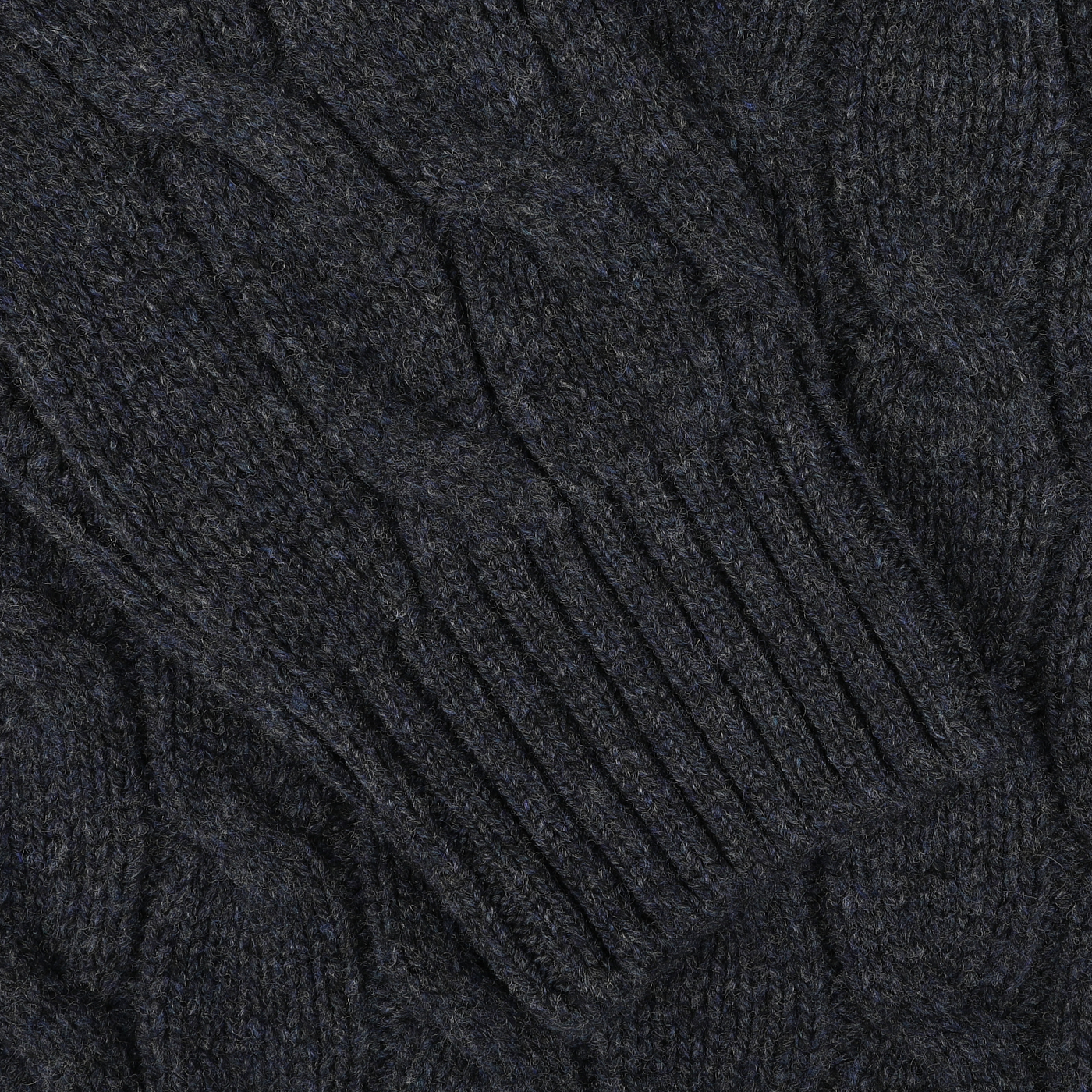 A close-up of the dark blue chunky cable-knit fabric with a prominent pattern and ribbed cuff detail from the Dark Blue Wool Cable Knit Rollneck by Gran Sasso, made from pure virgin wool.