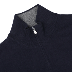 The Gran Sasso Dark Blue Wool Cashmere 1/4 Zip Sweater, featuring a high collar and partially open silver zipper, lays flat to display its light gray inner lining.