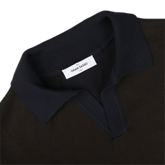 Close-up of a dark brown Gran Sasso Extra Fine Merino LS Polo Shirt, featuring a folded ribbed collar and a white label stitched inside.