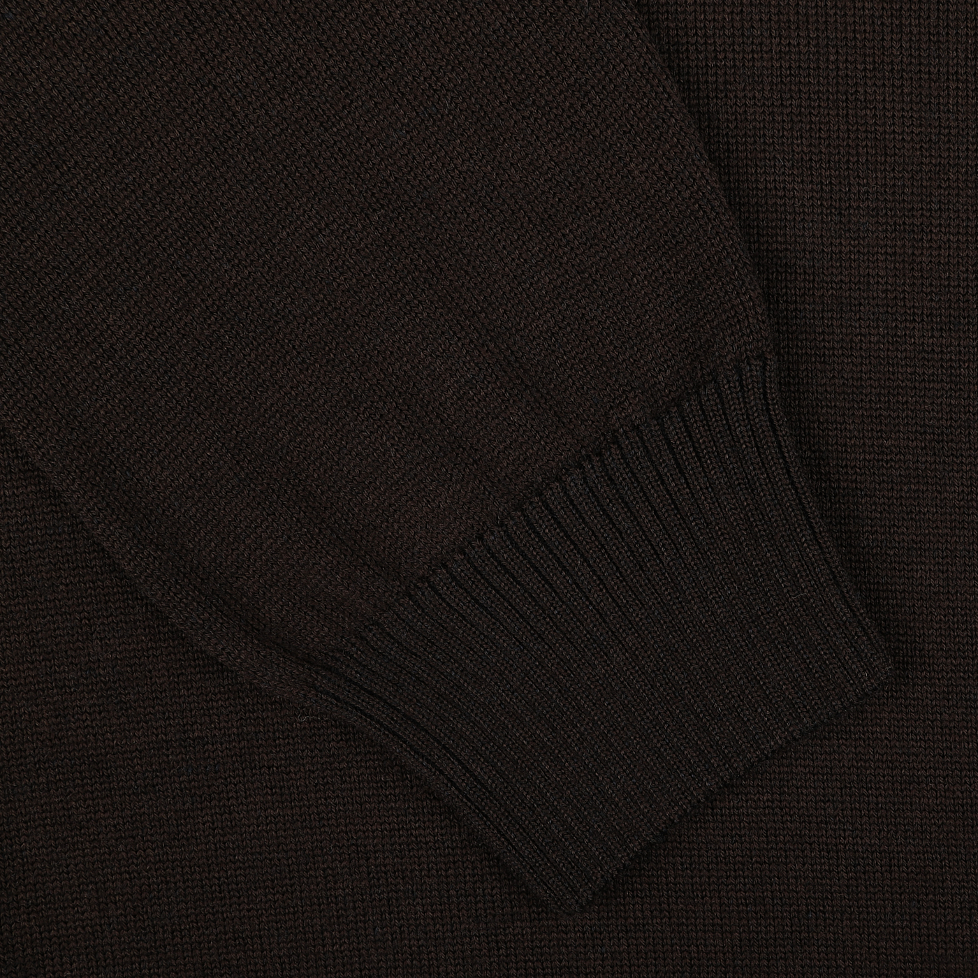 Close-up of the sleeve of a dark brown ribbed knit Gran Sasso Dark Brown Extra Fine Merino LS Polo Shirt, set against a matching dark brown textile background.