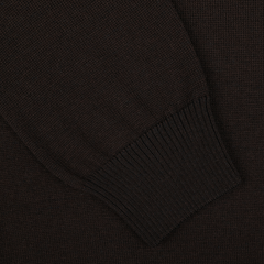 Close-up of the sleeve of a dark brown ribbed knit Gran Sasso Dark Brown Extra Fine Merino LS Polo Shirt, set against a matching dark brown textile background.