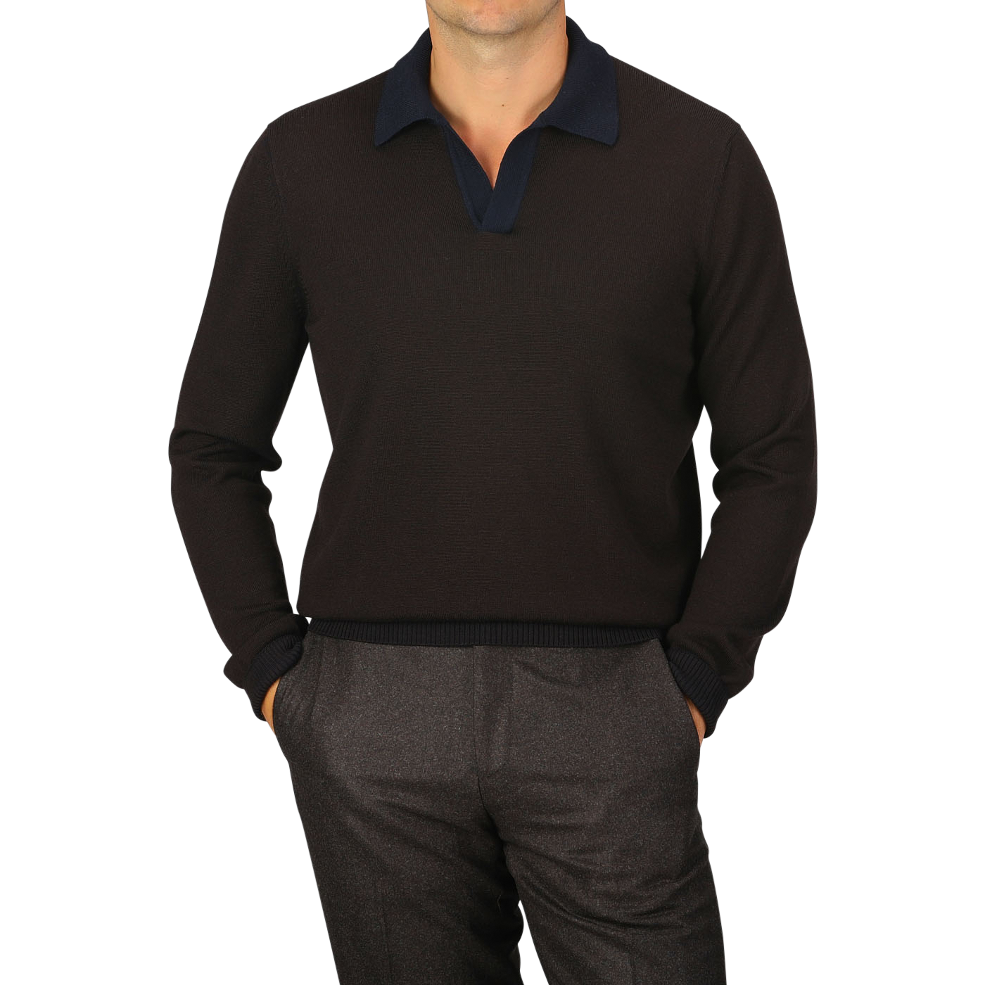 A man is standing with his hands in his pockets, wearing a dark brown long-sleeve collared sweater crafted from extra-fine merino wool by Gran Sasso and dark pants against a light gray background. His face is not visible.