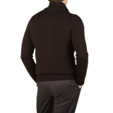 The back view of a man wearing a Dark Brown Merino Wool Button Cardigan made by Gran Sasso.