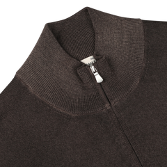 Close-up of the Dark Brown Vintage Merino Zip Cardigan by Gran Sasso, featuring a high, ribbed collar and a partially visible zipper. A white clothing tag inside the collar enhances its vintage appeal.