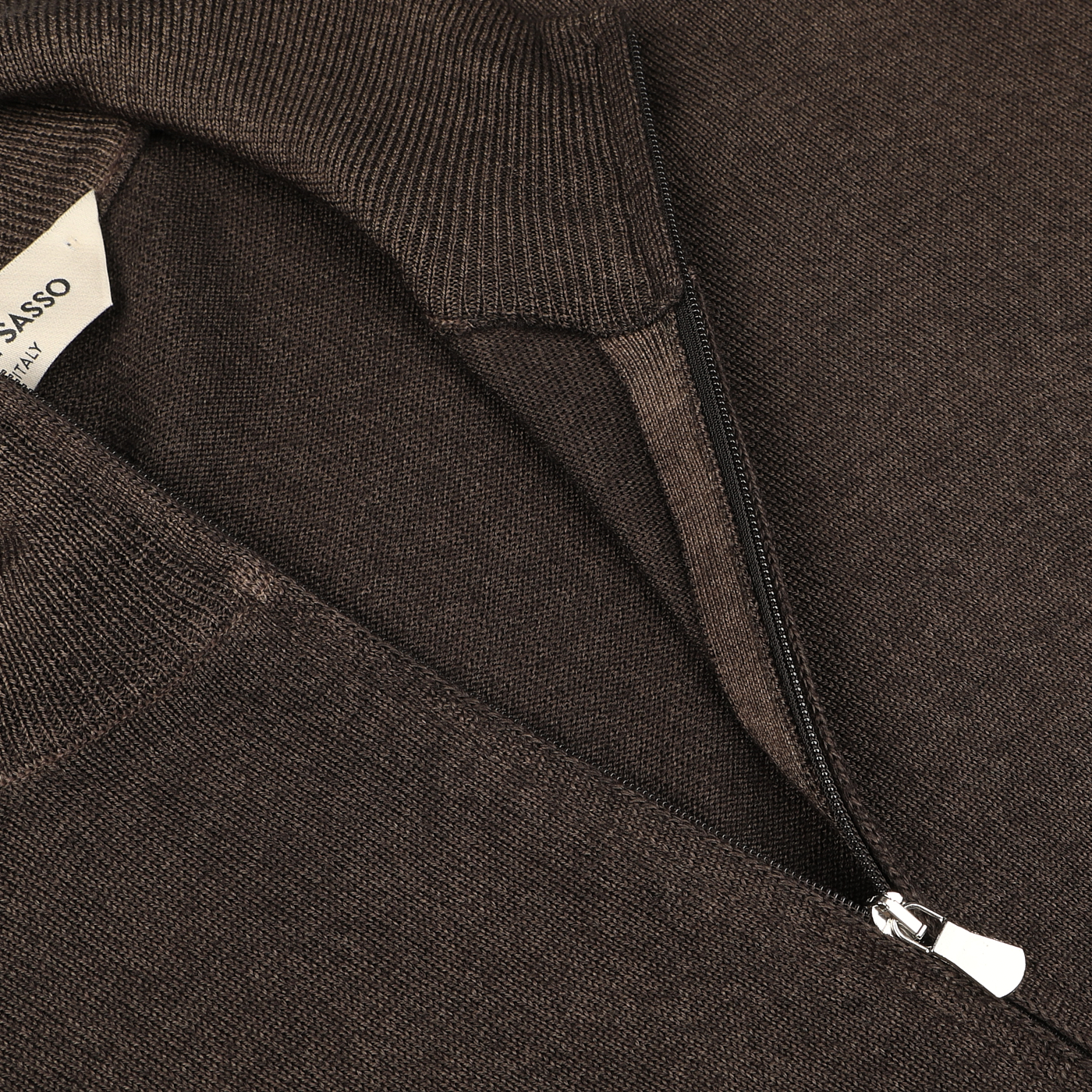 Close-up of the Gran Sasso Dark Brown Vintage Merino Zip Cardigan, featuring a knitted fabric with a quarter zipper. A white label is partially visible under the collar, adding to its vintage feel.