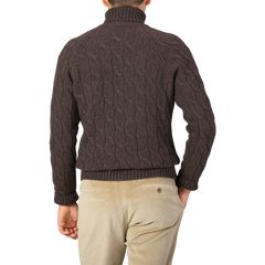 A person with short hair, seen from behind, is wearing a Gran Sasso Dark Brown Wool Cable Knit Rollneck made of pure virgin wool and light beige corduroy pants.