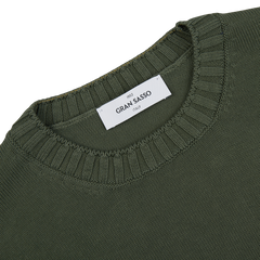 The back of a Gran Sasso Dark Green Egyptian Cotton Crewneck Sweater with a label on it.