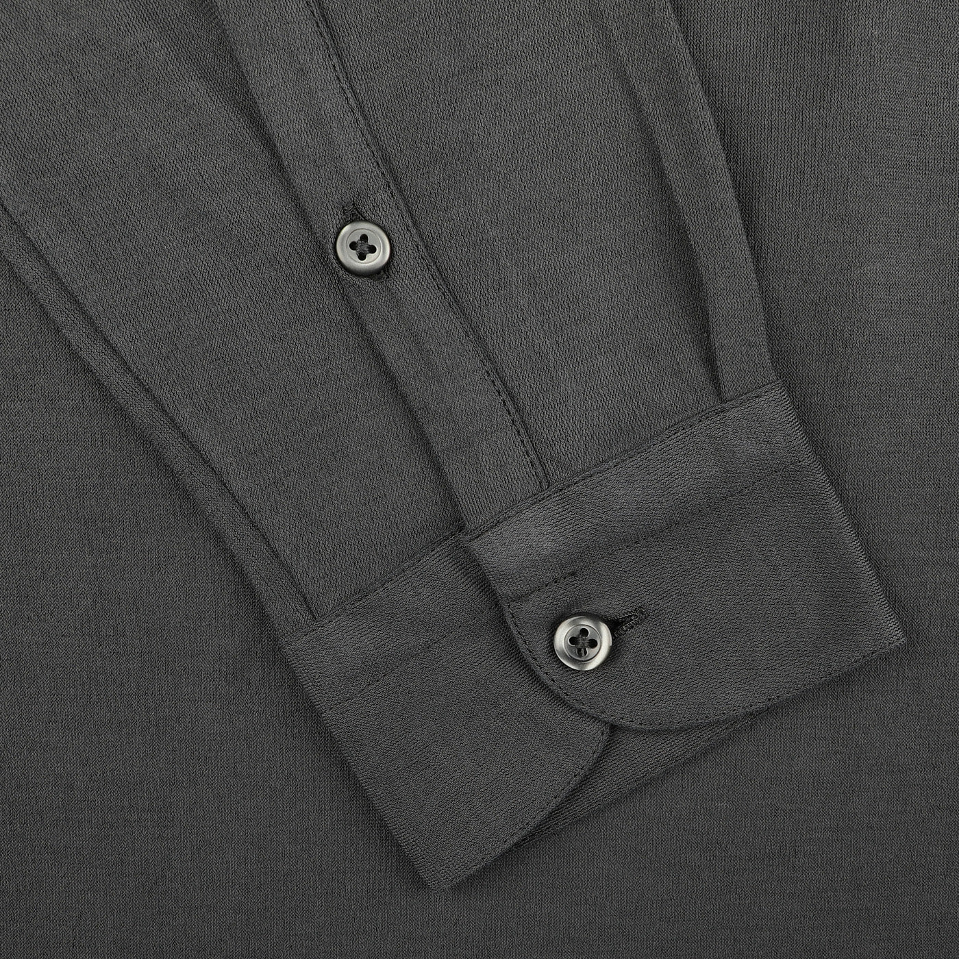 Close-up of Gran Sasso's Dark Grey Washed Cotton Popover Shirt, highlighting its slim-fit elegance with cuff and button details, crafted from pure cotton jersey on a plain background.