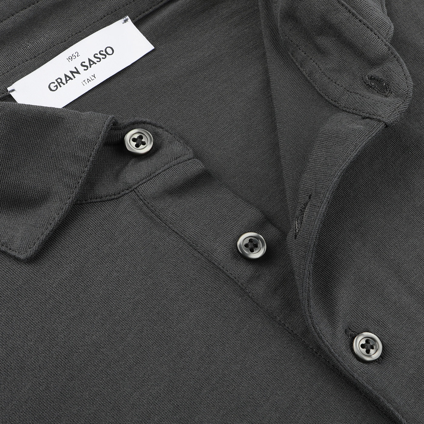 Close-up of the Dark Grey Washed Cotton Popover Shirt by Gran Sasso, made from pure cotton jersey, showcasing the "Gran Sasso Italy" label near the neckline with three stylishly undone buttons in a slim fit design.