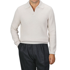 A person is wearing an Ecru Beige Chunky Knit Wool Polo Shirt by Gran Sasso, paired with dark gray pants. The background is plain gray.