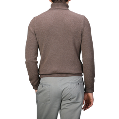 A person wearing a Fawn Brown Air Wool Rollneck by Gran Sasso and gray pants is shown from the back.