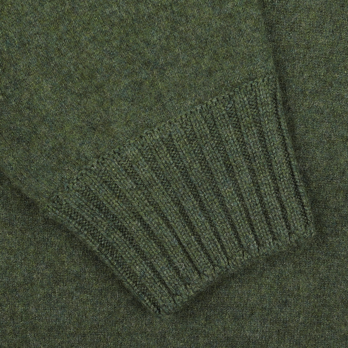 Close-up of a Gran Sasso Green Felted Cashmere Crewneck Sweater sleeve, highlighting the ribbed knit cuff detail.