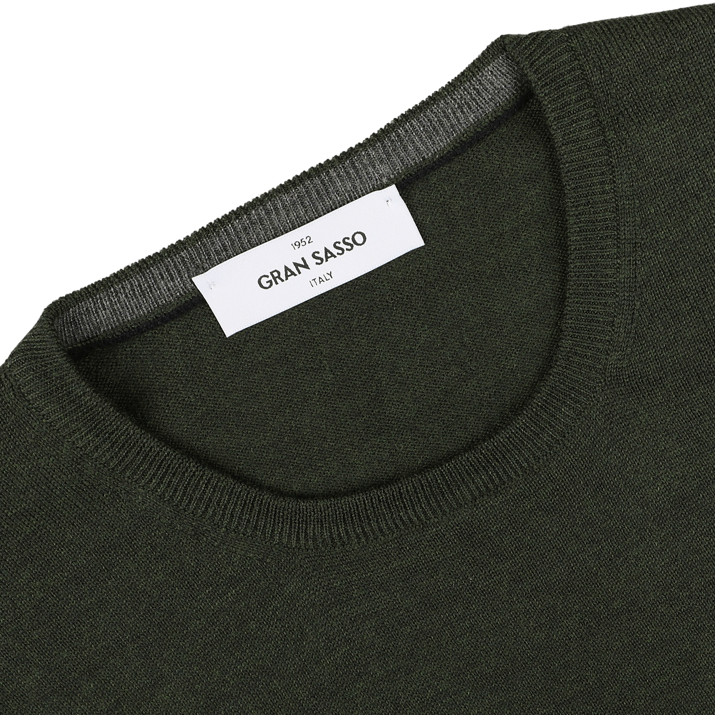 A close-up of the Green Melange Extra Fine Merino Crew Neck sweater highlights its "Gran Sasso" label on the collar, underscoring its premium merino quality.