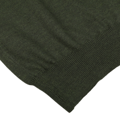 Close-up of the Green Melange Extra Fine Merino Crew Neck by Gran Sasso, showcasing the texture and hem of the garment, highlighting its high-quality merino fabric.